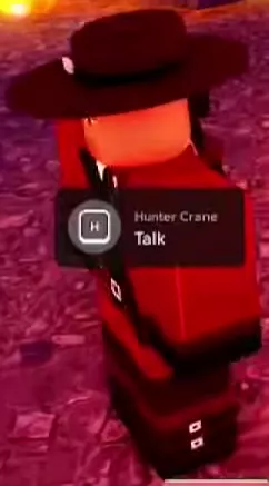 Hunter Crane wearing a wide-brimmed dark hat and red outfit.