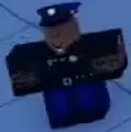 Director Valen wearing a blue cap, dark uniform and blue trousers.